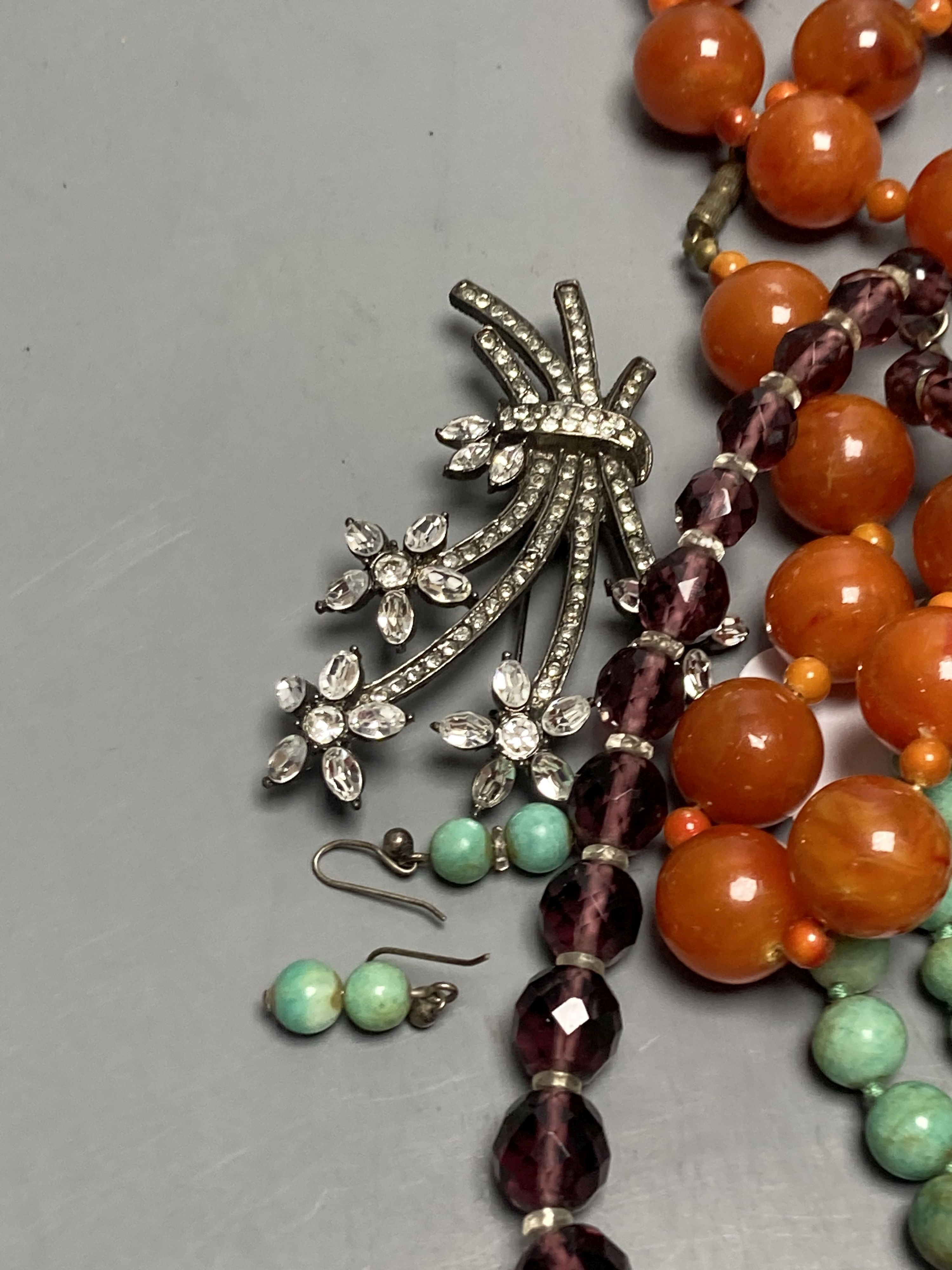 A turquoise bead necklace and pair of earrings, two other necklaces and two brooches including Indian? paste set.